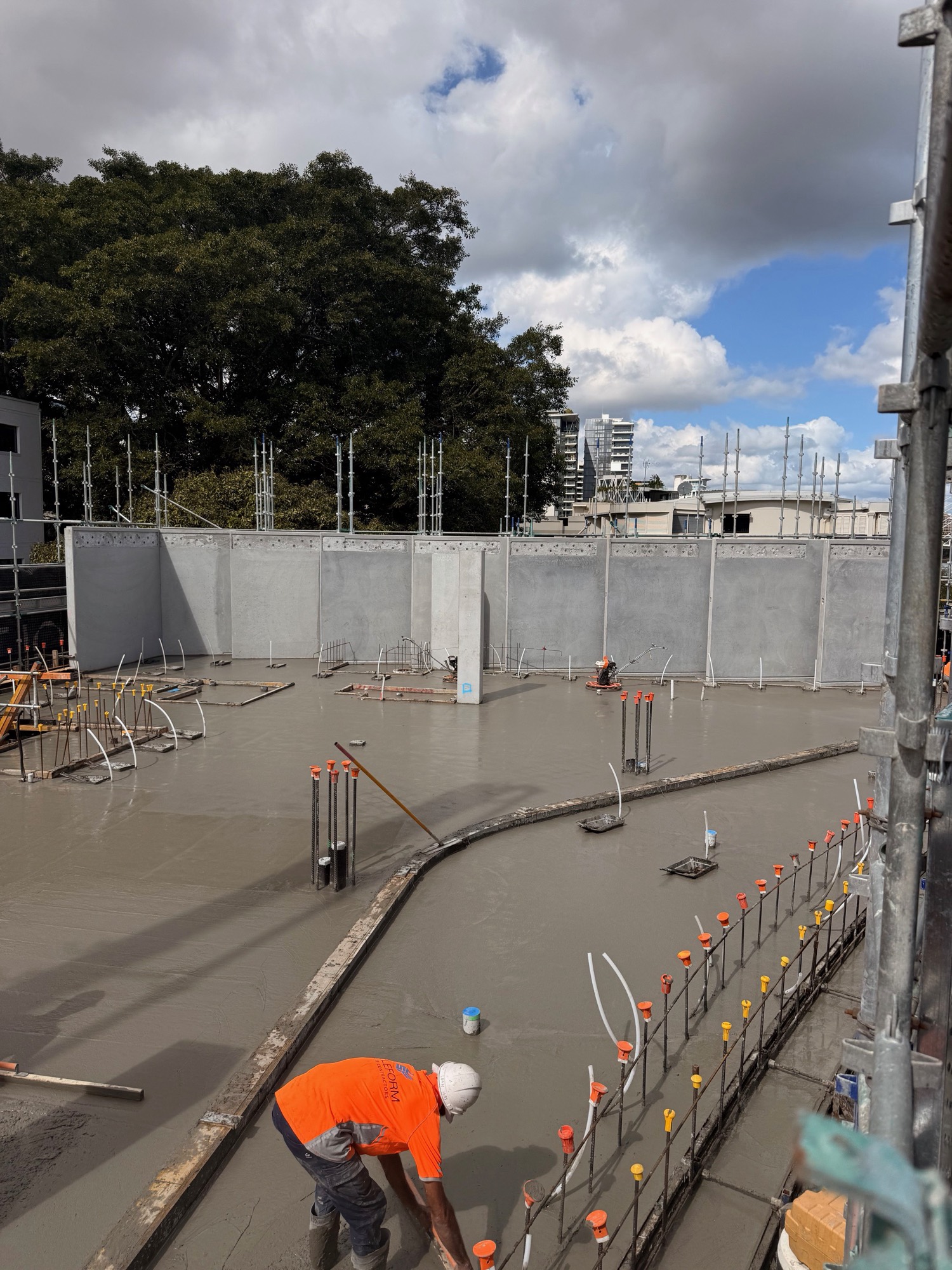 A worker screeding the freshly poured slab