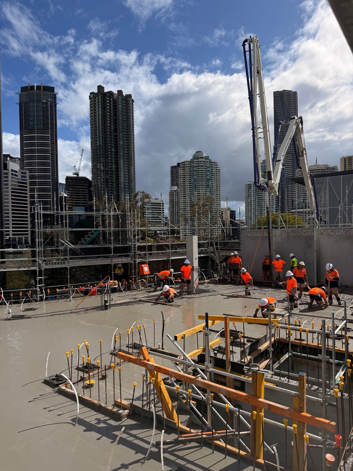 The concrete pour underway on the deck, with the Brisbane CBD beyond